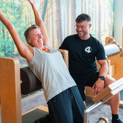 Mitgliederin und Trainer am five Gerät für den Rücken im SPIRIT4